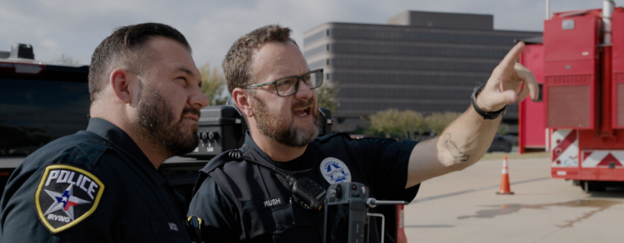 Irving Police officers with drone controller coordinating near Verizon reliable connectivity equipment.