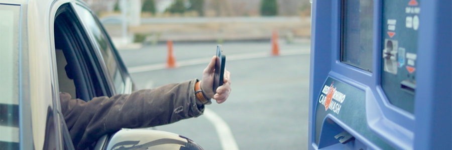 Full|EverWash customer paying at kiosk with mobile phone