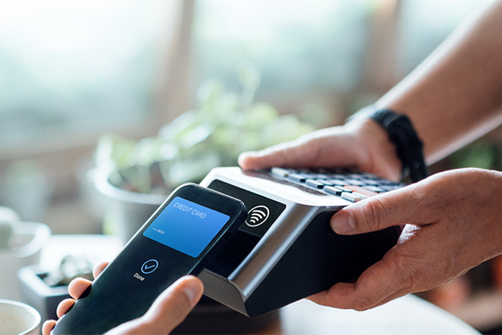 Tile|In-store customer completing touchless payment via smartphone