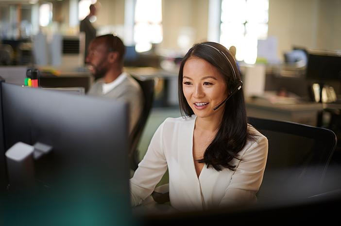 Tile|Women using computer wearing headset