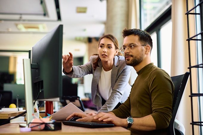 man woman looking at monitor.jpg