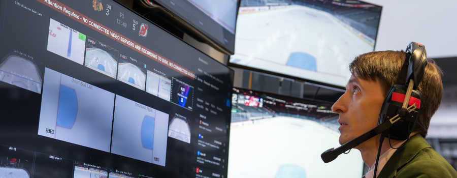 NHL telecast engineer looking at screens.jpg