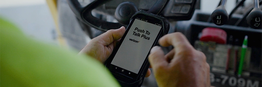 Full|Alley-Cassetty employee using Verizon Push to Talk Plus technology on smartphone