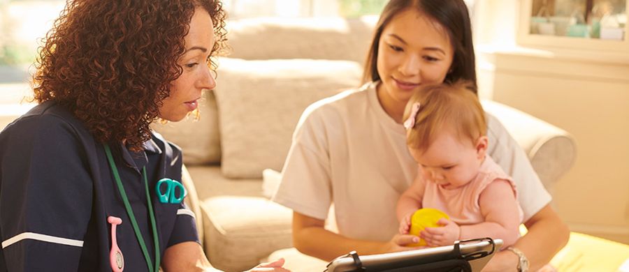 Full|Home healthcare nurse meeting with mother and young daughter