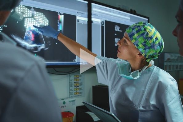 Tile| Female surgeon reviewing medical imaging with colleague