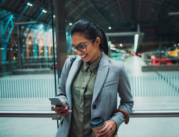Tile|Woman on phone with a coffee in a hand