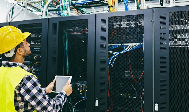 Tile | Engineer with hard hat in server room
