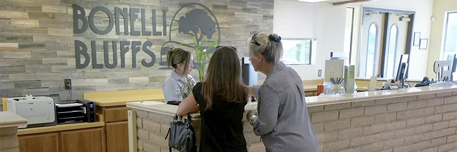 Wide | Customers Checking In At Reception Desk