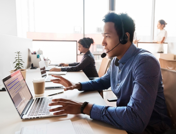 Sqre|Workers wearing headsets and sitting at desks