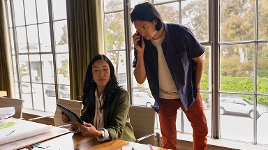 Card | Woman showing tablet to man on phone