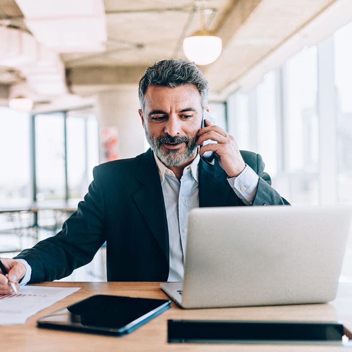 square-businessman-on-phone-with-laptop-and-tablet_5eab4e44-277f-4781-a303-f2e983103d0d.jpg