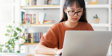 Tile| A girl studying and looking at laptop