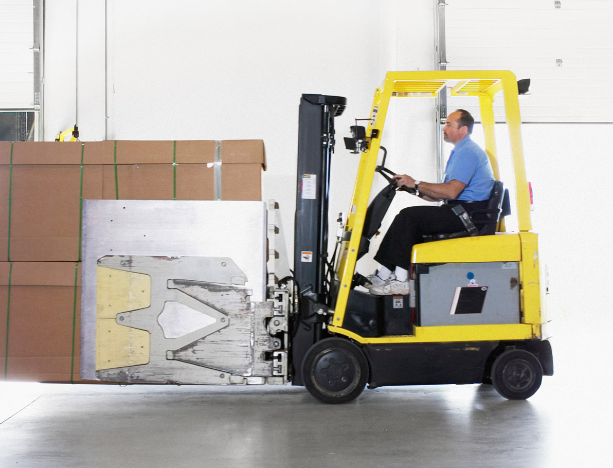 Sqre|Employee using a forklift to load large cartons onto a truck