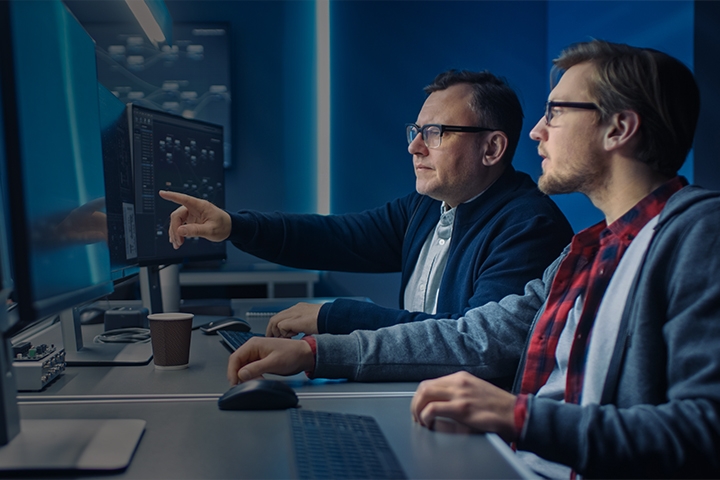 Tile|Two professional IT programmers discussing data while working in data center